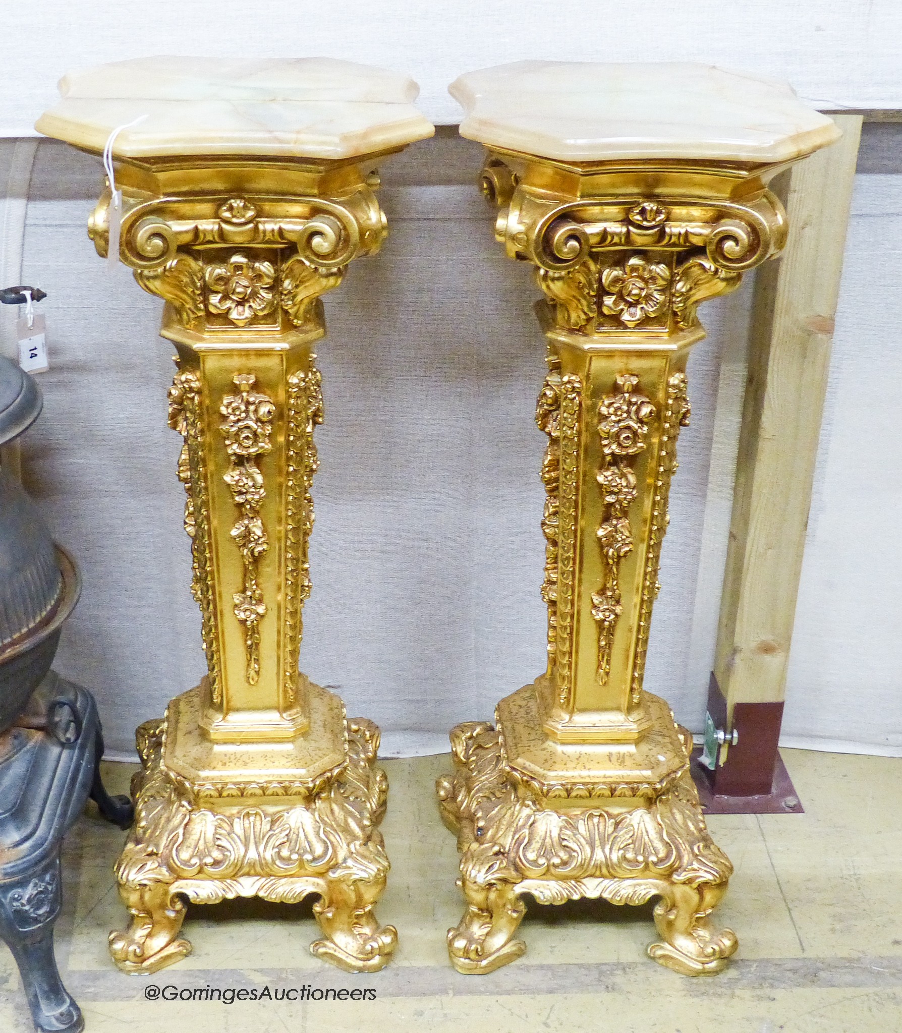 A pair of onyx top gilt pedestals, height 98cm